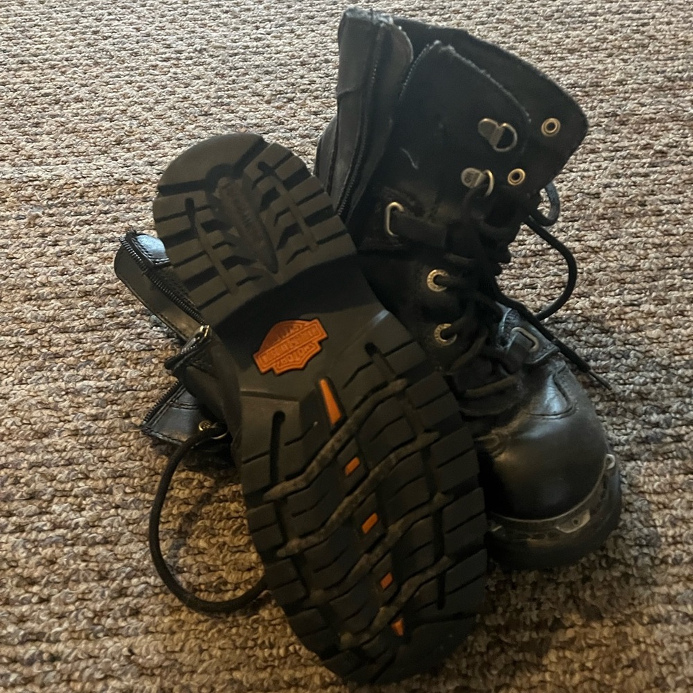 Black rugged high-top boots with thick rubber sole and lace-up design